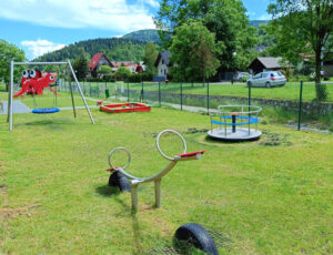 Urocze zdjęcie z małą karuzelą i konikiem - radosna zabawa dla najmłodszych, tuż obok naszego obiektu.